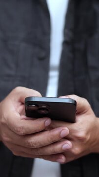 man holds smart phone in her hands and scrolls through the news feed. Close up of hand uses mobile. point finger on screen, texting text message.