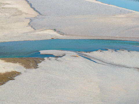 Aerial view of Drina river with gravel banks and clear blue water in Crna Bara, Macva District, Serbia.