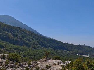 Fototapeta premium Green mountain slope landscape under clear blue sky