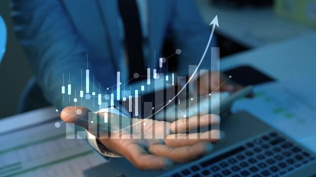 Holographic business stock market chart animation hand holding, Business person holding a glowing holographic financial chart with rising bars and arrow over a laptop