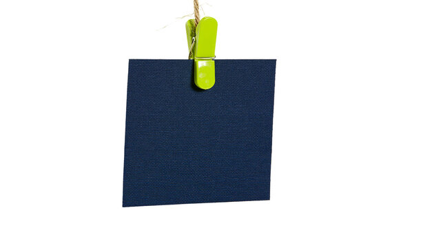 Dark blue square paper note held by green clothespin on string
