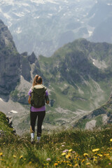 Obraz premium Woman Backpacker Hiking on Rocky Mountain Trail
