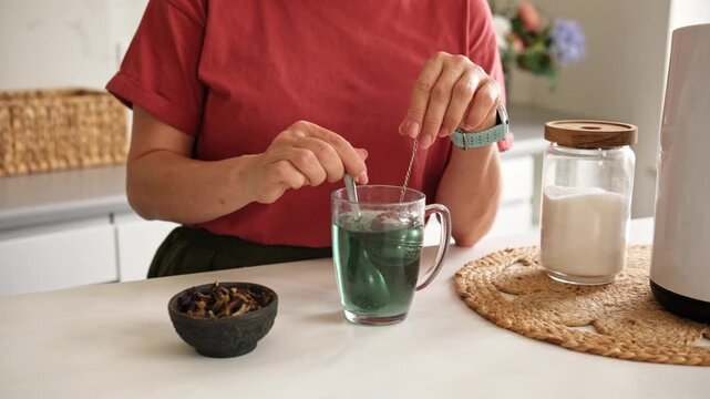 Woman Making Blue Matcha Tea In Home Kitchen, Close-Up