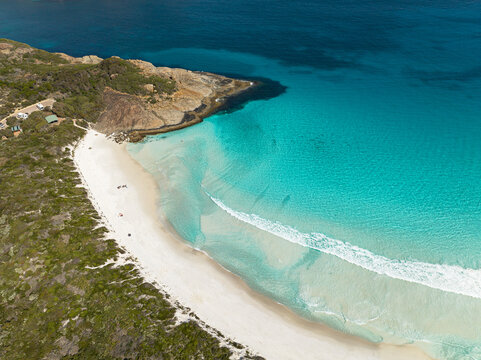 Aerial view of Wharton Beach with its pristine white sand and turquoise water, surrounded by rocky headlands and coastal vegetation in the Shire of Esperance, Western Australia, Australia.
