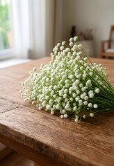 Fototapeta premium Floral decoration and natural beauty, white babys breath flowers on a rustic wooden table indoors, wedding and event decor