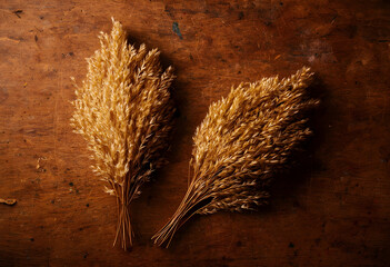 Fototapeta premium Autumn harvest and rustic decor, dried golden wheat bundles on a dark wooden table, natural fall season background