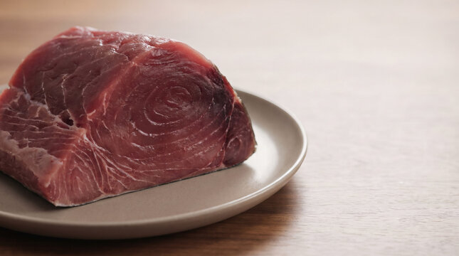 Fresh Raw Yellowfin Tuna Loin Portion on a Plate for Cooking or Sushi