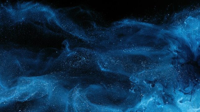Glittering liquid wisps and mist form a blue color storm in darkness