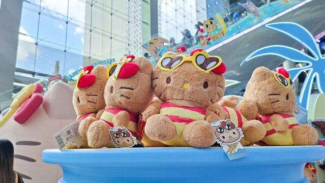 group of tanned brown Hello Kitty Sanrio plush dolls wearing summer swimsuit at Terminal 21 Asok on August 17, 2026 in Bangkok, Thailand.