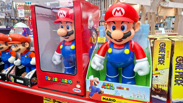 large super mario action figure in packaging displayed on shelf at retail toy store with nintendo video game collectible merchandise on July 29, 2026 in Bangkok, Thailand.