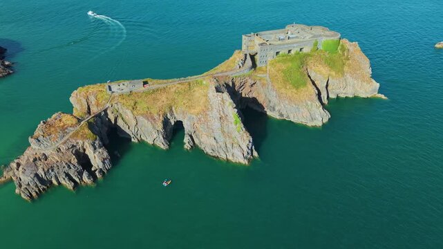 St Catherines Island and 19th-century Palmerston fort in Tenby, Pembrokeshire, turquoise coastal water washing against steep rocky cliffs, South Wales