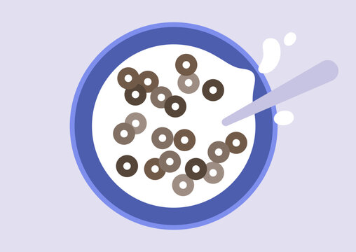 A bowl filled with chocolate loops cereal sits on a table, swimming in creamy milk, A spoon rests inside it, capturing the essence of a joyful breakfast experience.