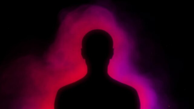 Human silhouette stands before swirling red and purple smoke in a dark setting
