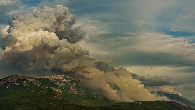 Massive pyrocumulus cloud rising above Monte Morrone during wildfire, smoke plume against sky. ,Maiella National Park, Abruzzo, Italy