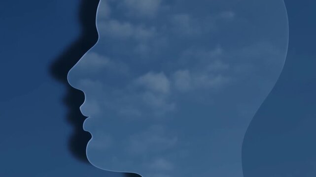 Human head profile silhouette with cloud texture against blue background in a static conceptual composition