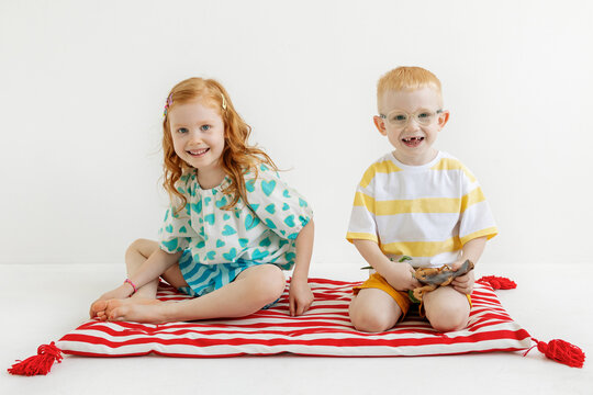 Children play together on a colorful mattress