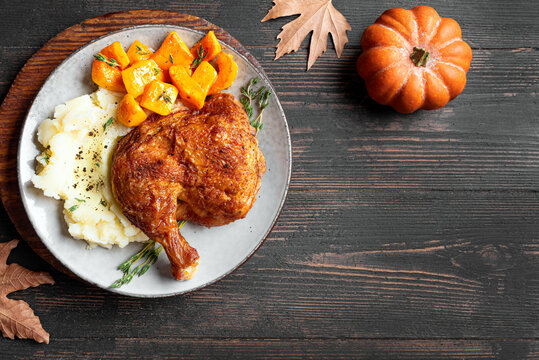 Autumn meal: chicken quarter with glazed pumpkin and mashed potato
