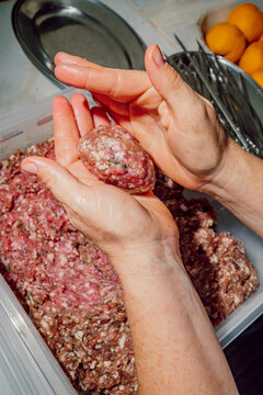 Hands shaping seasoned minced meat into traditional kofte patties