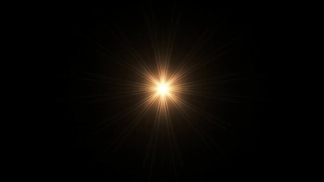 Golden starburst light glowing against black background with radiant rays extending outward