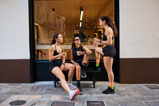 Friends meet at cafe to enjoy drinks and share stories outside