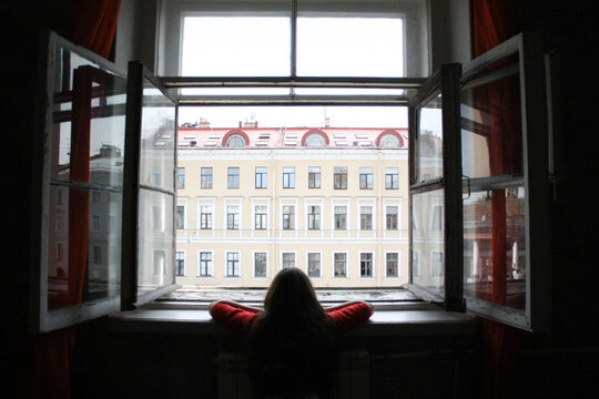 A girl looking outside from the window