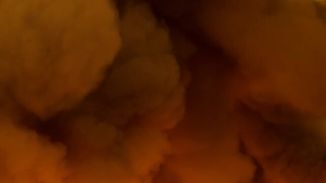 Orange smoke cloud filling the entire frame with dense billowing layers and warm glowing color