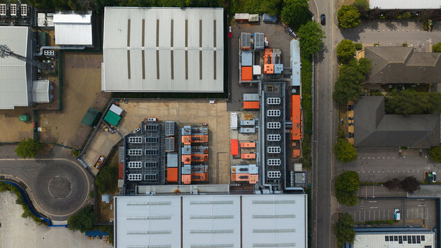 Aerial view of a data center facility featuring rows of external cooling units and HVAC systems for AI technology infrastructure in Hemel Hempstead, England, United Kingdom.