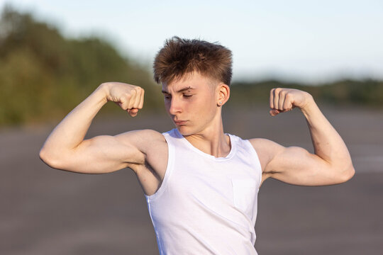 Teenage boy flexing his muscles