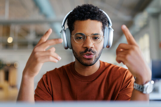 Man communicating during a video call wearing headphones