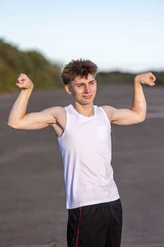 Teenage boy flexing his muscles