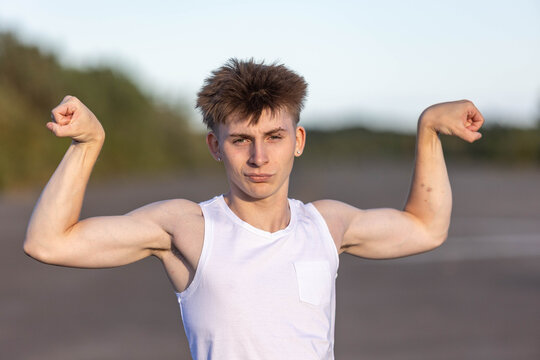 Teenage boy flexing his muscles
