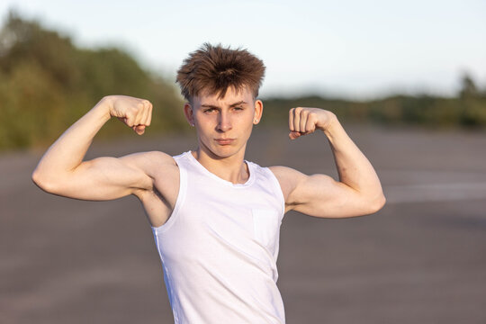 Teenage boy flexing his muscles