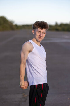 Teenage boy flexing his muscles