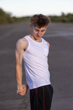 Teenage boy flexing his muscles