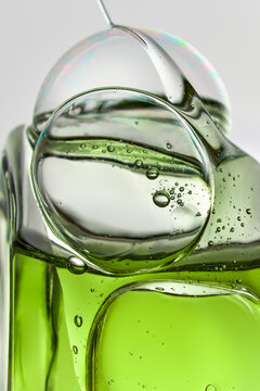 Abstract Cosmetic Serum Texture With Air Bubbles and Green Liquid