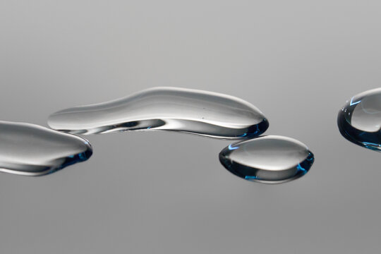 Close View of Water Droplets on a Smooth Gray Surface with Copy Space