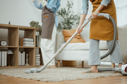 cleaning housekeeping housework with home vacuum; friends cleaning a bright together. cleaning guides buyer choices, housekeeping frames the scene, and housework adds useful meaning.