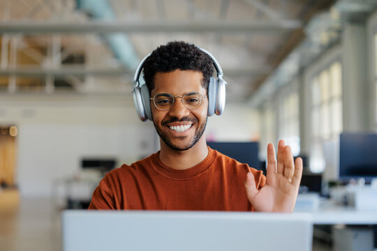 Man smiling greeting during online video call