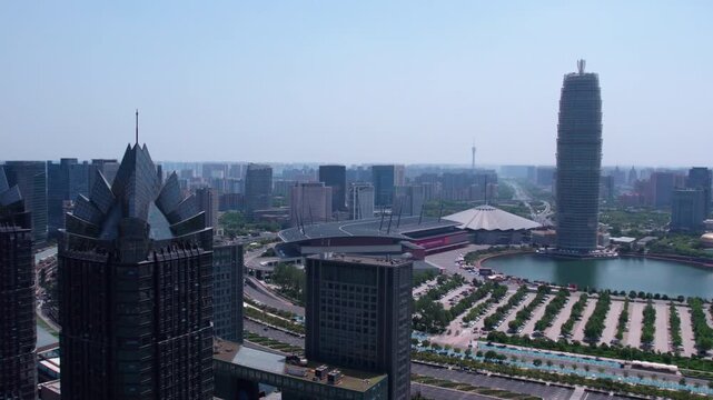 A daytime urban panorama featuring distinctive skyscrapers, a lake, and modern city architecture under a clear sky.