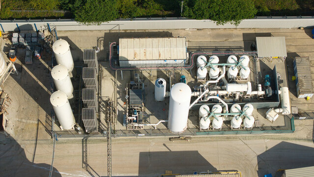 Aerial view of cryogenic storage tanks and gas vaporization systems at a glass manufacturing facility in Harlow, England, United Kingdom.