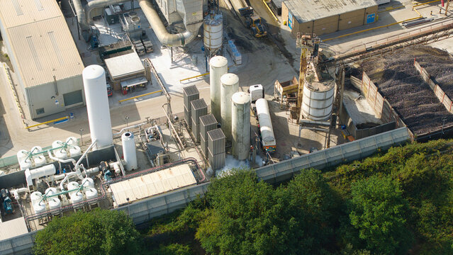 Aerial view of cryogenic storage tanks and gas vaporization systems at a glass manufacturing facility in Harlow, England, United Kingdom.