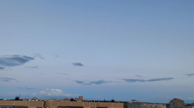 The sky above the city at sunset and sunrise is a clear blue