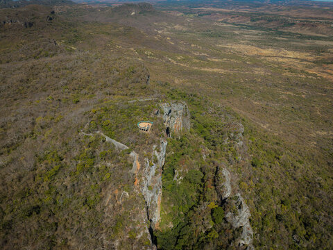 Aerial view of the French Mountain featuring rugged rocky cliffs and a scenic observation deck surrounded by dry tropical vegetation in Antsiranana, Diana, Madagascar.