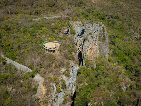 Aerial view of the French Mountain lookout point perched on a rocky cliff surrounded by lush forest and rugged terrain in Antsiranana, Diana, Madagascar.