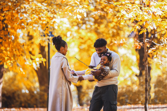  Mother holding her baby gently in a sunlit park