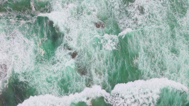Waves from the Pacific Ocean crash onto the beach in Fort Bragg, Mendocino, northern California in slow motion.