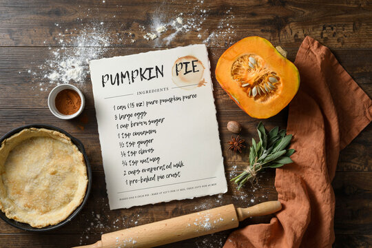 Rustic pumpkin pie recipe card on dark wood, autumn baking ingredients with fresh pumpkin, traditional holiday dessert preparation