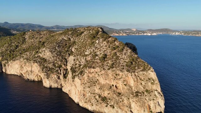 Aerial video of a rocky shoreline meeting crystal-clear Mediterranean waters along the coast of Mallorca, Spain, captured from directly above, 4k.
