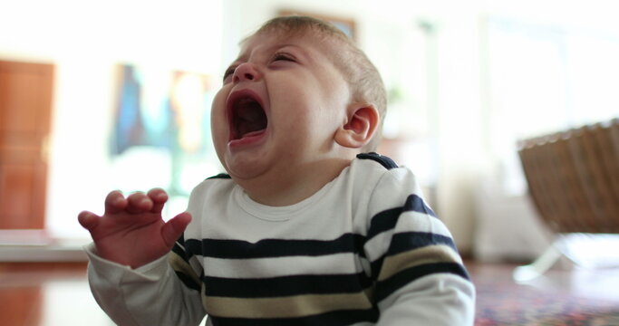 Upset angry baby crying uncontrollably. Infant toddler tantrum