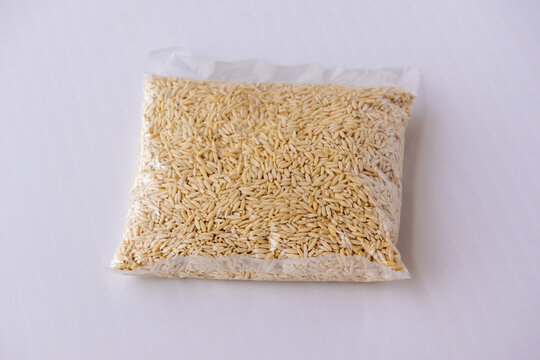 Dry handmade chutki pitha or semai pitha packed inside transparent plastic bag on white background. Traditional Bangladeshi rice flour pasta for sweet dessert.